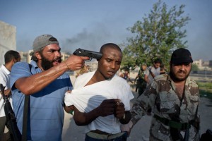 African migrant being tortured by Libyan militias